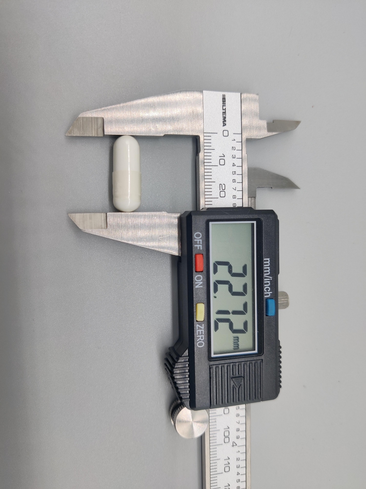 Skjutmått visar kapsellängd cirka 22,7 mm Core Arginine Complex