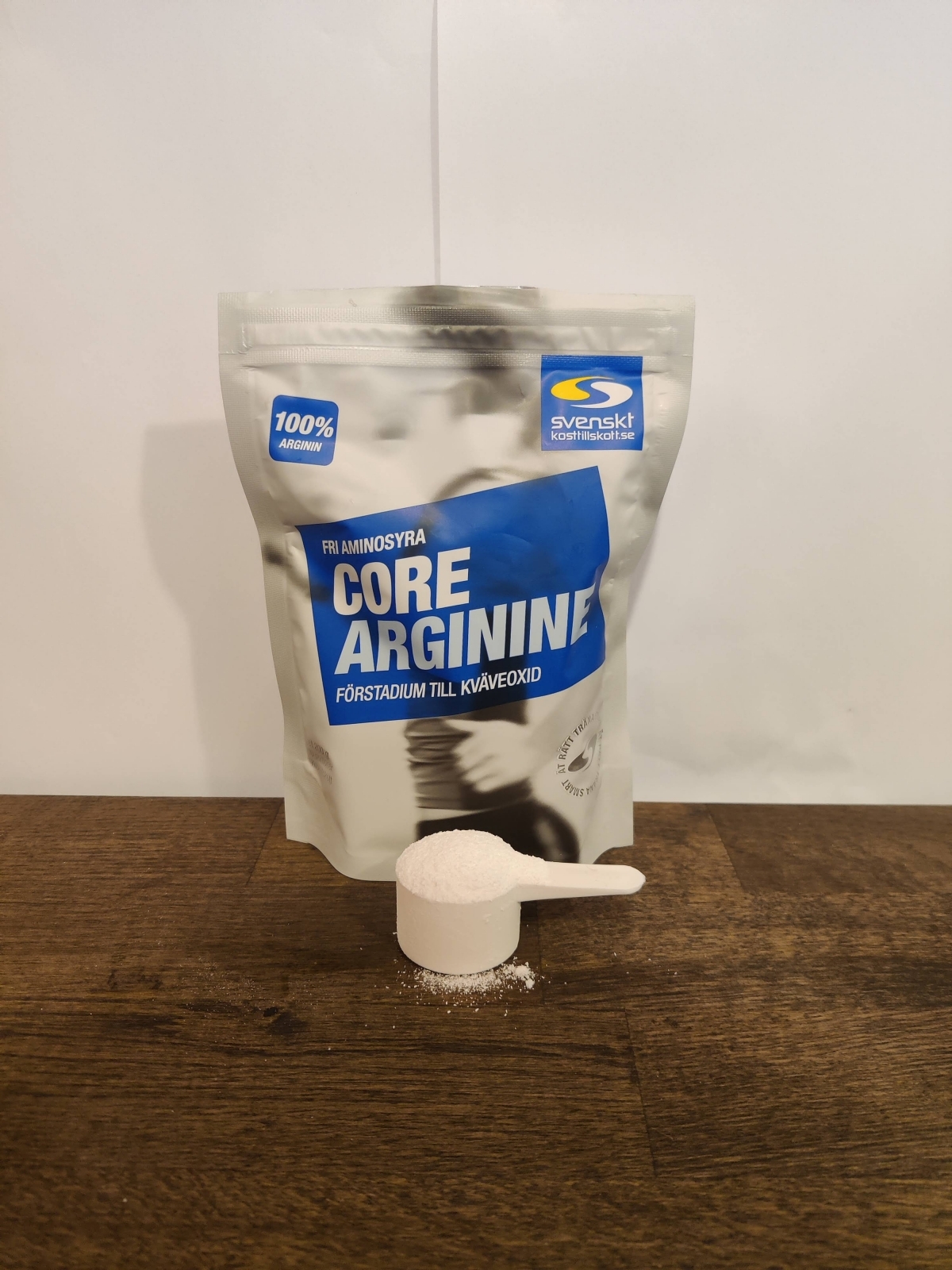 Core Arginine med uppmätt skopa framför påsen