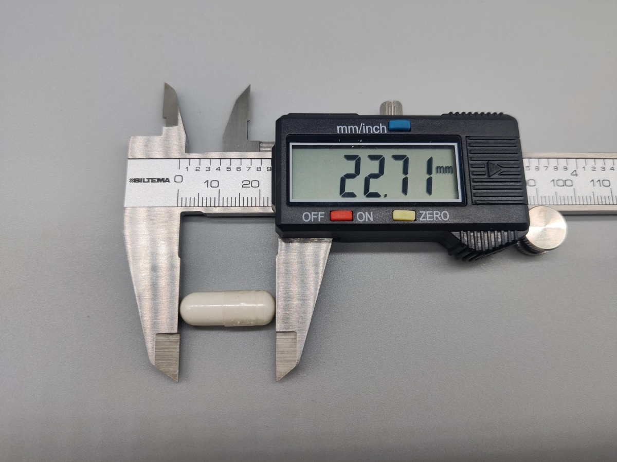 Skjutmått visar kapsellängd 22,7 mm för Core Lysine