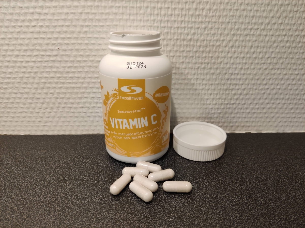 Healthwell Vitamin C öppnad burk med kapslar på bänken foto taget av oss