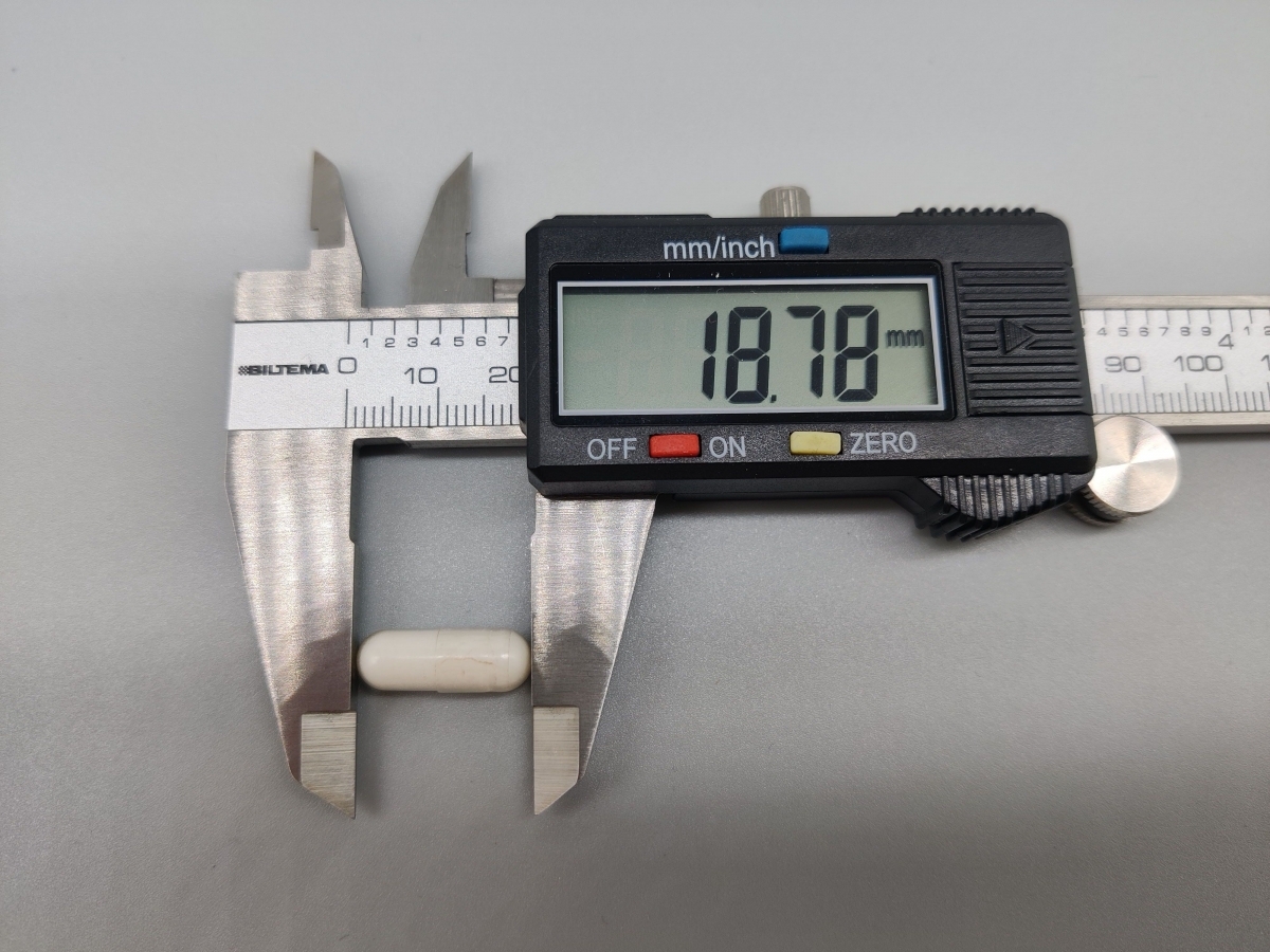 Skjutmått som visar kapselns längd 18,78 mm