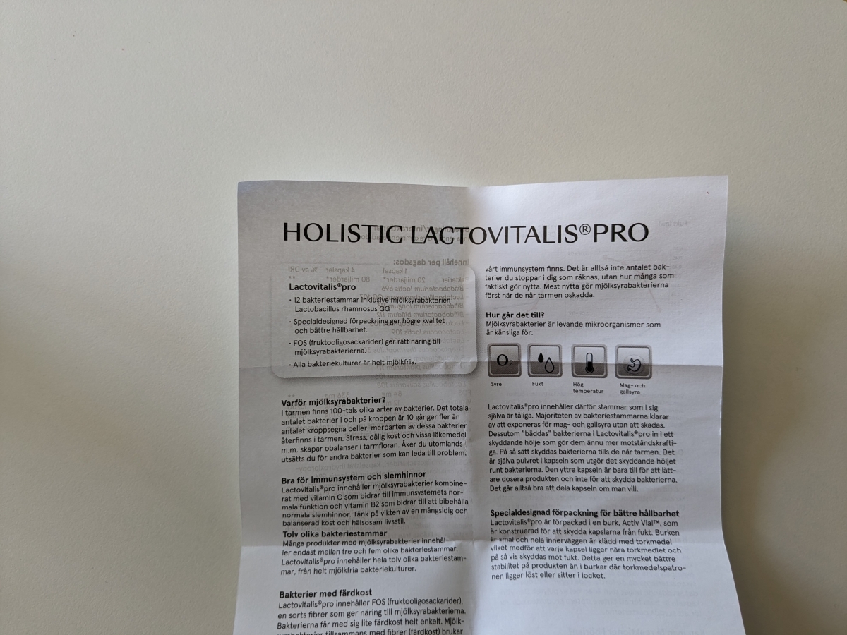 Informationsbladet till Holistic LactoVitalis Pro med text om 12 stammar, FOS och skyddande förpackning, fotat av oss
