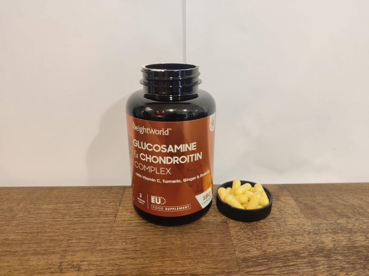 Weight World Glukosamin på träbord med framlagda kapslar, foto från vårt praktiska bruk